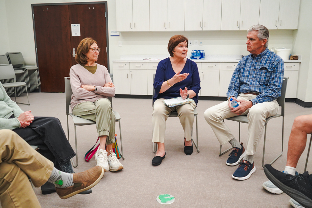 Char Fitzwater speaking with community members at a library event